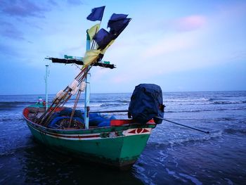 Ship moored on sea against sky