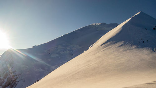 Scenic view of snowcapped mountains against clear sky