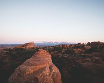 Rock formations on landscape against clear sky