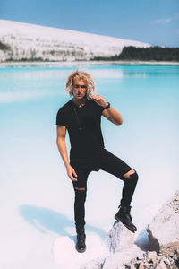 Portrait of man standing on sea shore