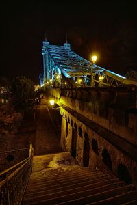 Illuminated bridge at night