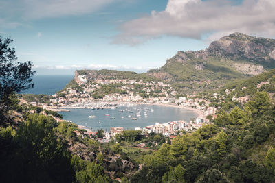 Scenic view of sea and mountains against sky