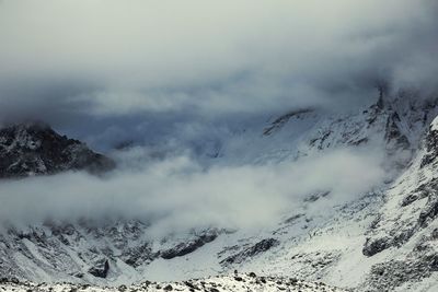 Scenic view of mountain range against cloudy sky