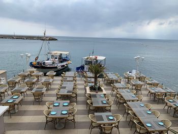 High angle view of sailboats moored on sea against sky