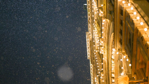 Illuminated building against sky at night