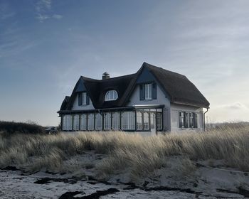 House on field against sky