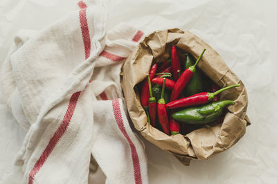 Chili peppers and jalepenos in a paper bag