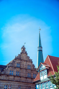 Low angle view of buildings against blue sky