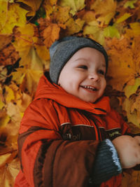 Portrait of cute boy in autumn leaves