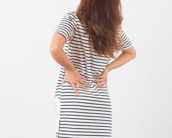 Rear view of woman standing against white background