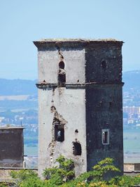 Abandoned building against clear blue sky