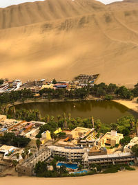 High angle view of townscape by river in town