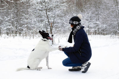 Woman with dog in snow