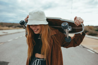 Portrait of smiling young woman standing outdoors