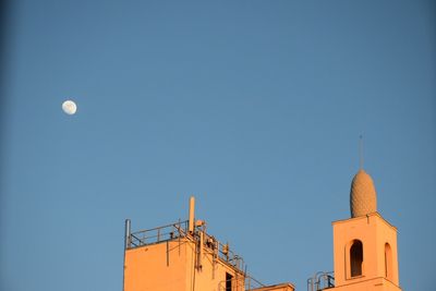 High section of built structure against clear blue sky