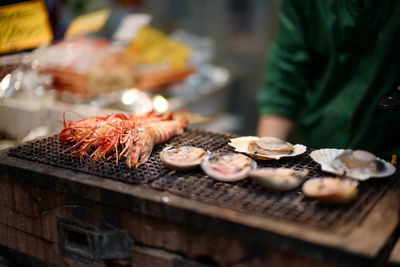 Close-up of meat on barbecue grill at market