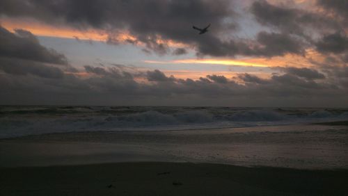Scenic view of sea against cloudy sky