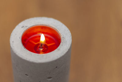 High angle view of lit candle on table