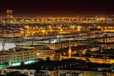 High angle view of city lit up at night