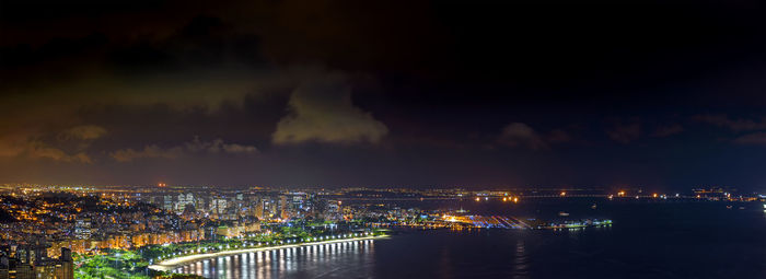 Illuminated rio de janeiro cityscape against sky at night