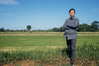 Portrait of man standing in field