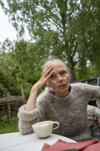 Senior woman drinking coffee in garden