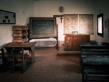 Empty chairs and table in building