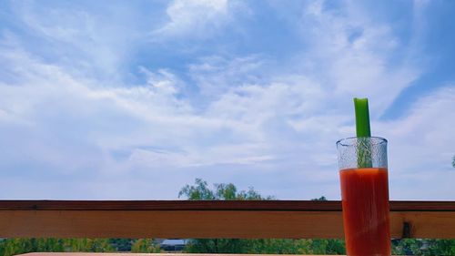 Close-up of drink against blue sky