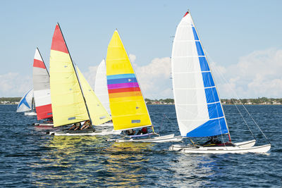 People in sailboats on sea