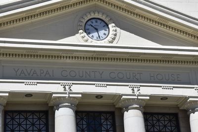 Low angle view of clock tower against building