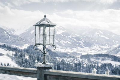 Built structure on snowcapped mountains against sky