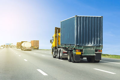 Vehicles on road against sky