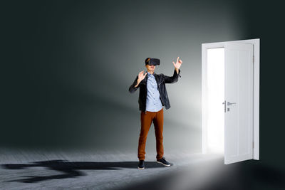 Businessman wearing virtual glasses standing in front of opened doors