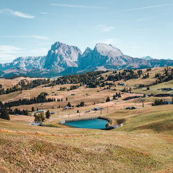 Scenic view of field and mountains against sky