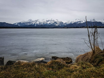 View of frozen lake against cloudy sky