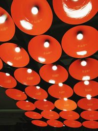 Low angle view of illuminated lanterns hanging at night