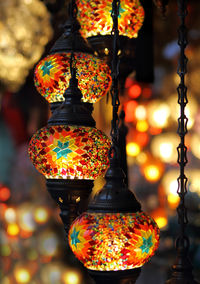 Close-up of illuminated lanterns hanging at night