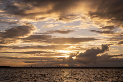 Beautiful amazon sunset clouds over the waters of negro river