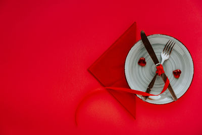 High angle view of clock on red wall