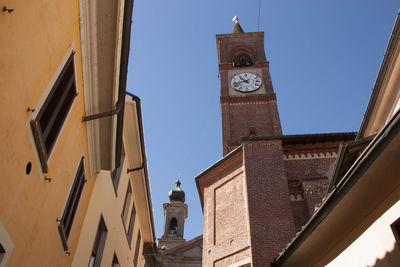 Low angle view of clock tower against clear sky