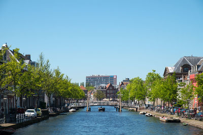 View of canal amidst buildings against sky