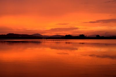 Scenic view of lake at sunset