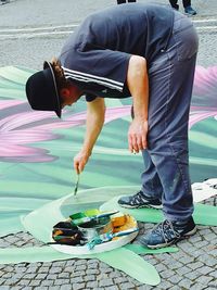 Full length of artist painting on street