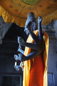 Statue of buddha against building