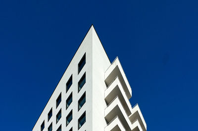 Low angle view of building against clear blue sky