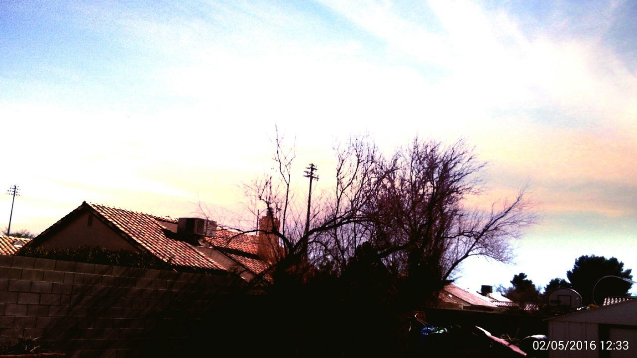 building exterior, architecture, built structure, house, sky, sunset, tree, residential structure, residential building, low angle view, bare tree, cloud - sky, building, city, silhouette, roof, outdoors, cloud, no people, branch