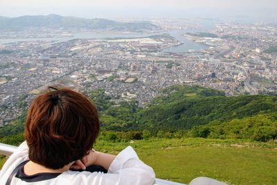 Rear view of man on landscape against mountain range