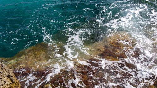 High angle view of rocks in sea