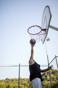 Low angle view of basketball hoop against sky