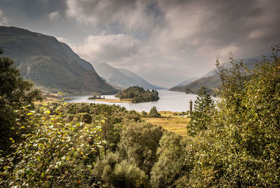 Scenic view of lake and mountains against sky